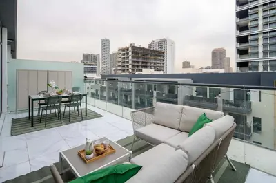 a balcony with a couch and a table on a building at Frank Porter - Serenity Lakes 5 in Dubai