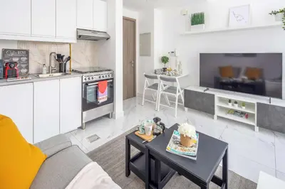 a living room with a couch and a table in a kitchen at Frank Porter - Serenity Lakes 5 in Dubai