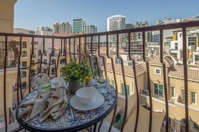 a table on a balcony with a view of the city at Frank Porter - Rokane G22 in Dubai