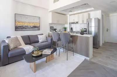 a living room with a couch and a kitchen at Frank Porter - Rokane G22 in Dubai