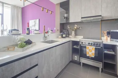 a kitchen with a sink and a stove at Frank Porter - MBL Royal in Dubai