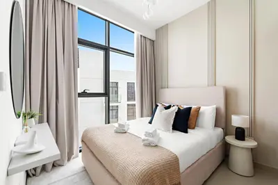 a bedroom with a large bed with a large window at Silkhaus Stylish 2BDR in Azizi Gardens with Pool & Gym in Dubai