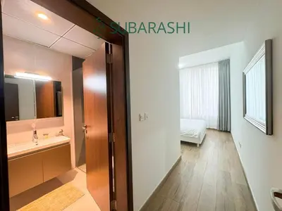 a bathroom with a sink and a mirror at Stylish 1BR Apartment in JVC in Dubai