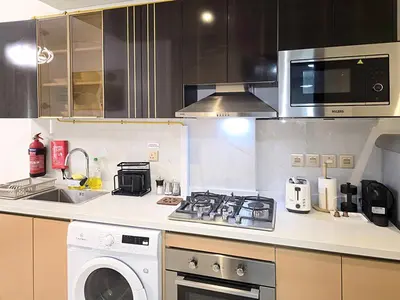 a kitchen with a stove and a microwave at Gemz by Danube - Al Furjan by Golden Casa in Dubai