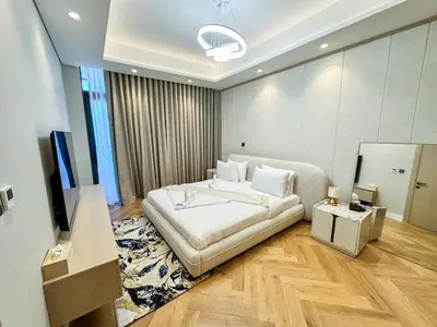 a bedroom with a bed and a flat screen tv at Vserve High Floor Bliss in Dubai's Iconic Skyline in Dubai
