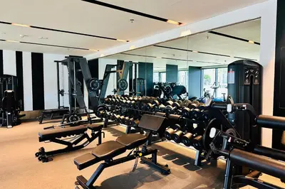 a gym with rows of tread machines and a mirror at Vserve High Floor Bliss in Dubai's Iconic Skyline in Dubai