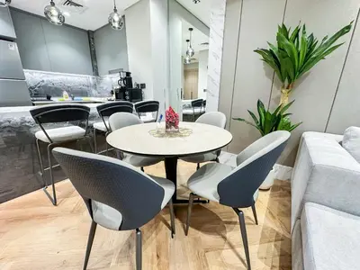 a dining room with a table and chairs at Vserve High Floor Bliss in Dubai's Iconic Skyline in Dubai