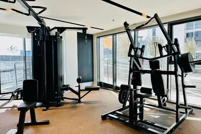 a gym with cardio equipment in a room with windows at Vserve I 1 BR - Luxury Escape in Business Bay in Dubai