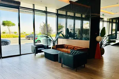 a living room with a couch and a table and windows at Vserve I 1 BR - Luxury Escape in Business Bay in Dubai