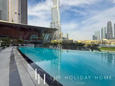 a large swimming pool with a city skyline in the background at LUX The Grande Signature Skyline Suite in Dubai
