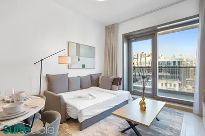 a hotel room with a bed and a couch and a table at Chic 1Bedroom with Stunning Marina View in Sparkle in Dubai