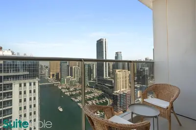 a balcony with chairs and a view of the city at Chic 1Bedroom with Stunning Marina View in Sparkle in Dubai