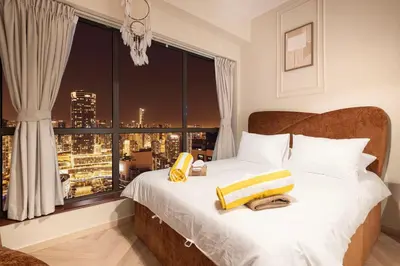 a bedroom with a bed with a large window at KYMA 2BDR JBR - Luxury Apartment with Full Panoramic Dubai Marina view in Dubai