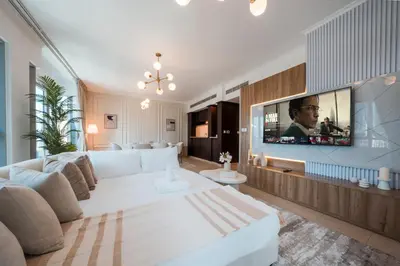 a living room with a white couch and a tv at Best location in Downtown Dubai in Dubai