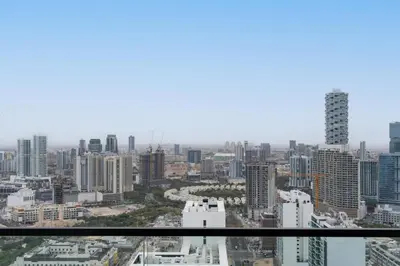 a view of a city from the top of a skyscraper at Cozy Studio with Sleek Design in JVC in Dubai