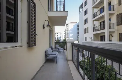 a balcony of a building with a chair on it at Elite LUX Holiday Homes - 1BHK Beachside Retreat at Port De La Mer, Dubai in Dubai