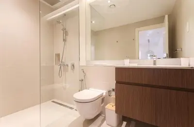 a bathroom with a toilet and a shower and a sink at Elite LUX Holiday Homes - 1BHK Beachside Retreat at Port De La Mer, Dubai in Dubai