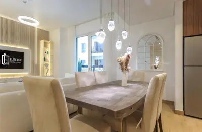 a kitchen and dining room with a wooden table and chairs at Elite LUX Holiday Homes - 1BHK Beachside Retreat at Port De La Mer, Dubai in Dubai
