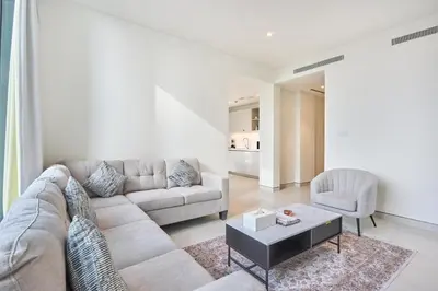 a living room with a couch and a table at STAY BY LATINEM Luxury 1BR Holiday Home CVG 710 Near Burj Khalifa in Dubai