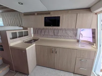 a small kitchen with a sink and a tv at Luna Rosa in Dubai