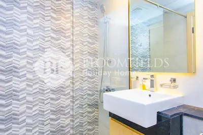 a bathroom with a sink and a shower at Bloomfields 1Br The Avenue Suite Bingahtti in Dubai