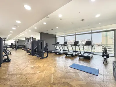 a gym with treadmills and ellipticals in a building at Wonderful Stay At Zaya Hameni - Best Amenities - Unique in JVC - Brand New Luxury Apartments in Dubai
