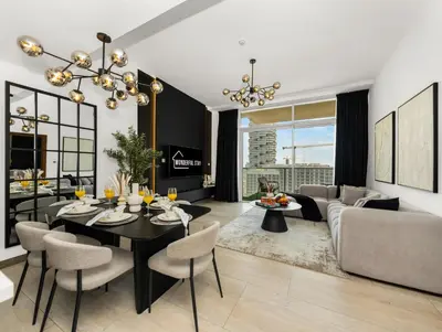 a living room with a dining table and a couch at Wonderful Stay At Zaya Hameni - Best Amenities - Unique in JVC - Brand New Luxury Apartments in Dubai