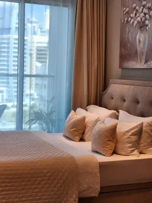 a bed with pillows in a bedroom with a window at STUDIO ONE Stunning Marina View - TIE in Dubai
