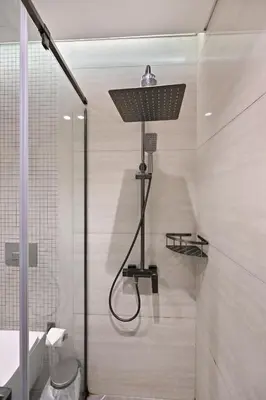 a shower with a shower head in a bathroom at Stunning 1 Bdr Luxury with Burj Khalifa View in Dubai