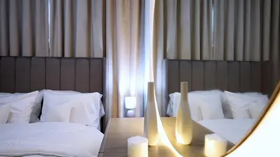 a mirror reflection of a bedroom with two beds at 2 Bedroom Elegant Apartment in Dubailand in Dubai