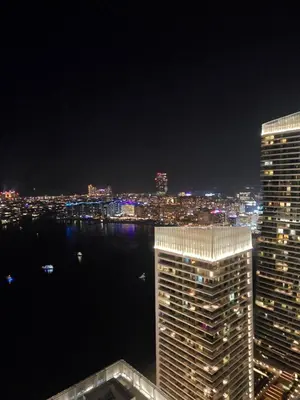 a view of a city skyline at night at Luxury Penthouse Retreat - Private Beach, Breathtaking Palm and Marina Views in Dubai