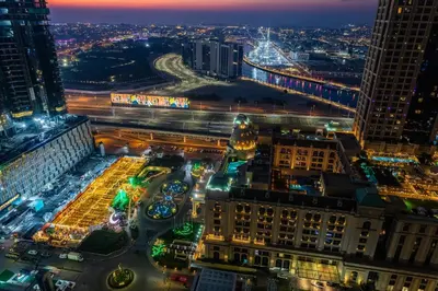 an aerial view of a city at night at Luxury 2Br Apt Stunning Views in Amna Tower by Simply Comfort in Dubai