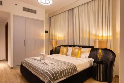a bedroom with a large bed with yellow pillows at Luxury 2Br Apt Stunning Views in Amna Tower by Simply Comfort in Dubai