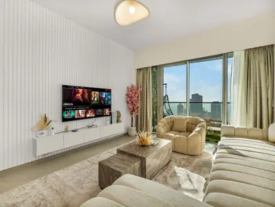 a living room with two couches and a tv at Grande Signature 2 Bedroom Apartments I Persian Gulf Views I Free Parking, Gym, Pool, Wi-Fi & PS5 I by Skyline Serenity in Dubai