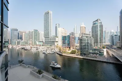 a river with boats in a city with tall buildings at GuestReady - Fabulous home with Marina Canal views in Dubai