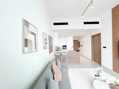 a living room with a couch and a table at Luxury & Comfort at Binghatti Amber with Balcony in Dubai