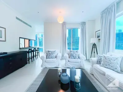 a living room with two white couches and a table at Luxury 2B Apt with Full Marina Views - Delphine in Dubai