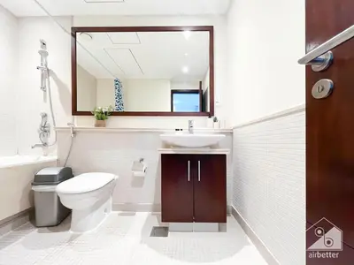 a bathroom with a toilet and a sink and a mirror at Luxury 2B Apt with Full Marina Views - Delphine in Dubai
