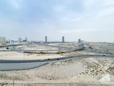 a highway in a city with buildings in the background at Sophisticated 1B Apartment in Belgravia Heights II in Dubai