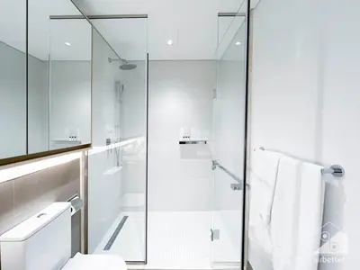 a bathroom with a glass shower stall and a toilet at Sophisticated 1B Apartment in Belgravia Heights II in Dubai