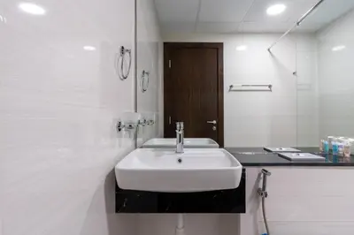 a bathroom with a white sink and a mirror at Delightful 2 Bedrooms In Jumeirah Village Circle in Dubai