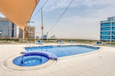 a swimming pool on the roof of a building at Restful studio Apartment in Dubai Sports City in Dubai