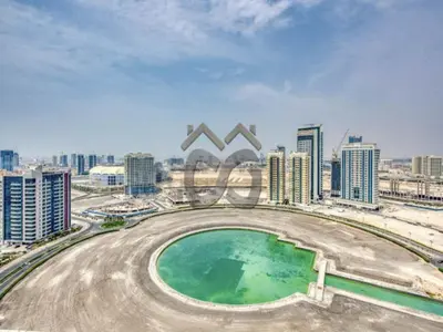 arial view of a city with a pool at Restful studio Apartment in Dubai Sports City in Dubai