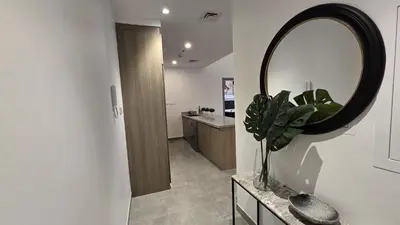 a bathroom with a large mirror and a sink at Stella Maris Marine view in Dubai