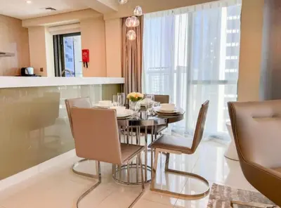 a dining room with a table and chairs at Luxury 2 Bedroom Apartment in Downtown in Dubai