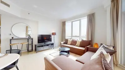a living room with a couch and a tv at Vacationer I Sophisticated 2 Bedroom Apartment I High Floor I Scenic Skyline Escape I Torch Tower - Marina in Dubai
