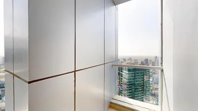 a room with a window with a view of a city at Vacationer I Sophisticated 2 Bedroom Apartment I High Floor I Scenic Skyline Escape I Torch Tower - Marina in Dubai