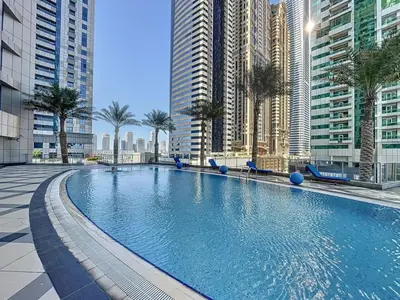 a large swimming pool in a city with tall buildings at Vacationer I Sophisticated 2 Bedroom Apartment I High Floor I Scenic Skyline Escape I Torch Tower - Marina in Dubai