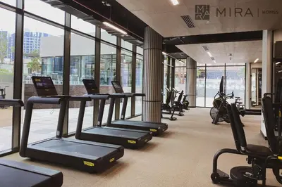 a gym with treadmills and ellipticals in a building at Mira Holiday Homes - newly and cosy studio with balcony in Business Bay in Dubai