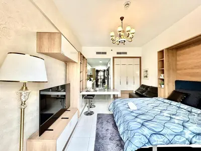 a bedroom with a bed and a living room at Homes2Retreat - Resort Living Close to Miracle Garden in Dubai